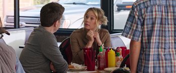 Movie still from “Vacation” (2015), directed by John Francis Daley – A woman sitting at a table in front of a man; Medium shot, Over the shoulder angle