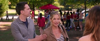 Movie still from “Vacation” (2015), directed by John Francis Daley – A woman standing next to a man in a park; Medium shot, Over the shoulder angle