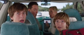 Movie still from “Vacation” (2015), directed by John Francis Daley – A group of people in the back seat of a car; Close Up shot, Over the shoulder angle