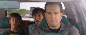 Movie still from “Vacation” (2015), directed by John Francis Daley – A man and a boy in the back seat of a car; Close Up shot, Over the shoulder angle