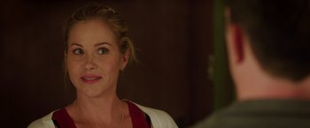 Movie still from “Vacation” (2015), directed by John Francis Daley – A woman's face in a dark room; Close Up shot, Over the shoulder angle