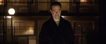 Movie still from “Vacation” (2015), directed by John Francis Daley – A man in a black robe standing in front of a building; Close Up shot, Over the shoulder angle