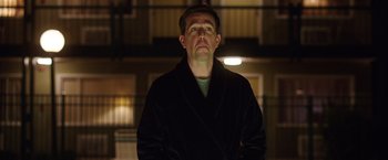 Movie still from “Vacation” (2015), directed by John Francis Daley – A man standing in the dark wearing a robe; Medium shot, Low angle
