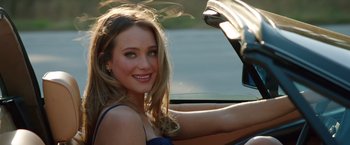 A beautiful young woman sitting in a car