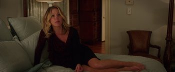 Movie still from “Vacation” (2015), directed by John Francis Daley – A woman sitting on top of a bed in front of a window; Medium shot, Over the shoulder angle