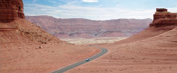 Movie still from “Vacation” (2015), directed by John Francis Daley – A car driving down a road in the middle of the desert; Extreme Wide shot, High angle