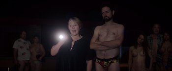 Movie still from “Vacation” (2015), directed by John Francis Daley – A woman and a man are standing in the dark; Medium shot, Low angle