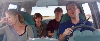 Movie still from “Vacation” (2015), directed by John Francis Daley – Three young men sitting in the back of a car; Medium shot, Over the shoulder angle