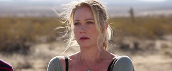 Movie still from “Vacation” (2015), directed by John Francis Daley – A woman with blonde hair wearing a green necklace; Close Up shot, Over the shoulder angle