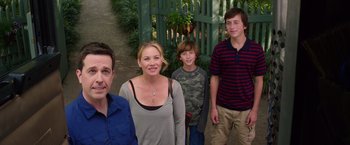 Movie still from “Vacation” (2015), directed by John Francis Daley – A group of people standing next to each other in front of a green gate; Medium shot, High angle