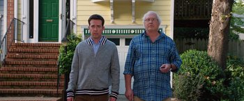 Movie still from “Vacation” (2015), directed by John Francis Daley – Two men standing next to each other in front of a house; Medium shot, Over the shoulder angle
