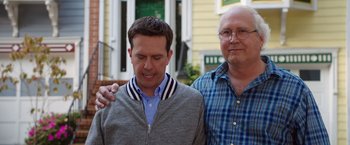 Movie still from “Vacation” (2015), directed by John Francis Daley – Two men standing next to each other in front of a building; Medium shot, Over the shoulder angle