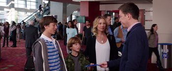 Movie still from “Vacation” (2015), directed by John Francis Daley – A group of people standing around in a room; Medium shot, Over the shoulder angle