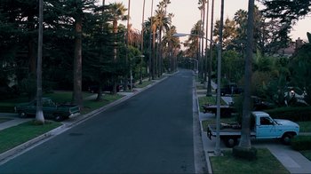 Movie still from “Valentine's Day” (2010), directed by Garry Marshall – An empty street lined with palm trees at dusk; Extreme Wide shot, High angle