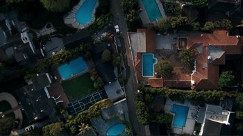 Movie still from “Valentine's Day” (2010), directed by Garry Marshall – An aerial view of a residential area with swimming pools; Extreme Wide shot, Overhead angle