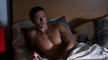 Movie still from “Valentine's Day” (2010), directed by Garry Marshall – A man laying in a bed with a pillow; Medium shot, High angle