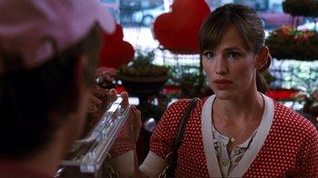 Movie still from “Valentine's Day” (2010), directed by Garry Marshall – A woman in a red polka dot dress holding a trumpet; Close Up shot, Over the shoulder angle