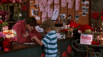 Movie still from “Valentine's Day” (2010), directed by Garry Marshall – A young boy standing at the counter of a restaurant; Medium shot, Over the shoulder angle