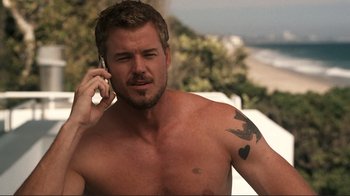 Movie still from “Valentine's Day” (2010), directed by Garry Marshall – A man with a tattoo is talking on a cell phone; Close Up shot, High angle