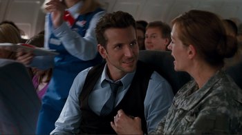 Movie still from “Valentine's Day” (2010), directed by Garry Marshall – A man and a woman sitting next to each other on a plane; Medium shot, Over the shoulder angle