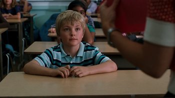Movie still from “Valentine's Day” (2010), directed by Garry Marshall – A young boy sitting at a table in a classroom; Close Up shot, Over the shoulder angle