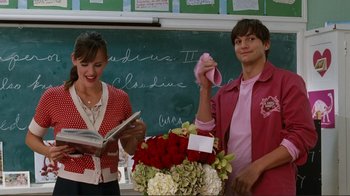 Movie still from “Valentine's Day” (2010), directed by Garry Marshall – A man and a woman standing in front of a chalkboard; Medium shot, Over the shoulder angle