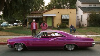 Movie still from “Valentine's Day” (2010), directed by Garry Marshall – A couple of men standing next to a purple car; Wide shot, High angle