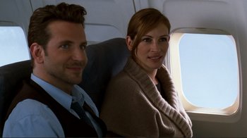 Movie still from “Valentine's Day” (2010), directed by Garry Marshall – A man and a woman sitting on a plane; Medium shot, Over the shoulder angle