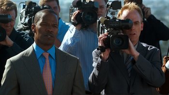 Movie still from “Valentine's Day” (2010), directed by Garry Marshall – A group of men standing next to each other holding cameras; Medium shot, Over the shoulder angle