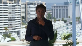 Movie still from “Valentine's Day” (2010), directed by Garry Marshall – A woman standing in front of a window with a city view in the background; Medium shot, Over the shoulder angle