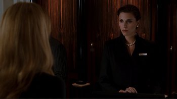 Movie still from “Valentine's Day” (2010), directed by Garry Marshall – A woman in a black suit and a woman in a black dress; Medium shot, Over the shoulder angle