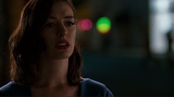 Movie still from “Valentine's Day” (2010), directed by Garry Marshall – A person looking sad with lights in the background; Close Up shot, Over the shoulder angle