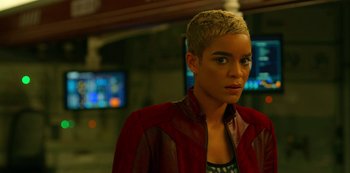 Movie still from “Another Life” (2019), created by Aaron Martin – A woman in a red and black jacket looking to her left; Close Up shot, Over the shoulder angle