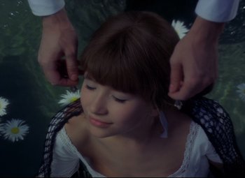 Movie still from “Valerie and Her Week of Wonders” (1970), directed by Jaromil Jires – A woman getting her hair combed by a man; Close Up shot, High angle