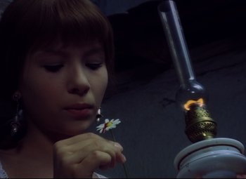 Movie still from “Valerie and Her Week of Wonders” (1970), directed by Jaromil Jires – A woman holding a flower in her hand; Close Up shot, Low angle