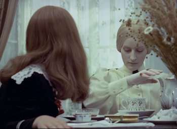 Movie still from “Valerie and Her Week of Wonders” (1970), directed by Jaromil Jires – Two women sitting at a table in front of each other; Medium shot, Over the shoulder angle