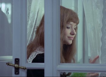 Movie still from “Valerie and Her Week of Wonders” (1970), directed by Jaromil Jires – A young girl looking out of a window; Close Up shot, Over the shoulder angle
