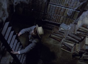 Movie still from “Valerie and Her Week of Wonders” (1970), directed by Jaromil Jires – A man wearing a hat is falling down a flight of stairs; Wide shot, Overhead angle