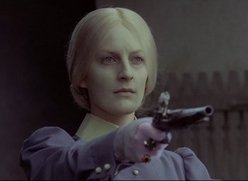 Movie still from “Valerie and Her Week of Wonders” (1970), directed by Jaromil Jires – A woman holding a gun while wearing gloves; Close Up shot, Over the shoulder angle