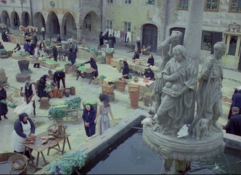 Movie still from “Valerie and Her Week of Wonders” (1970), directed by Jaromil Jires – A group of people sitting and standing around a fountain; Extreme Wide shot, High angle