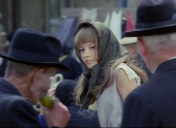 Movie still from “Valerie and Her Week of Wonders” (1970), directed by Jaromil Jires – A woman with a head scarf is standing next to a man; Close Up shot, Over the shoulder angle