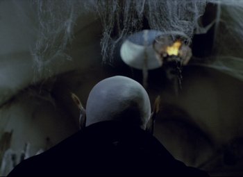 Movie still from “Valerie and Her Week of Wonders” (1970), directed by Jaromil Jires – A man with a bald head looking at a spider; Close Up shot, Over the shoulder angle