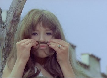 Movie still from “Valerie and Her Week of Wonders” (1970), directed by Jaromil Jires – A woman with a ring on her finger is holding her nose; Close Up shot, Low angle