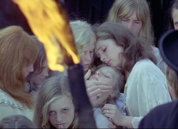 Movie still from “Valerie and Her Week of Wonders” (1970), directed by Jaromil Jires – A group of young people gathered around a fire; Close Up shot, High angle
