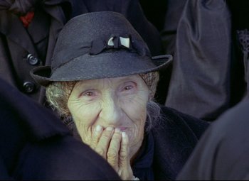 Movie still from “Valerie and Her Week of Wonders” (1970), directed by Jaromil Jires – An old woman wearing a black hat and a black jacket; Close Up shot, Over the shoulder angle