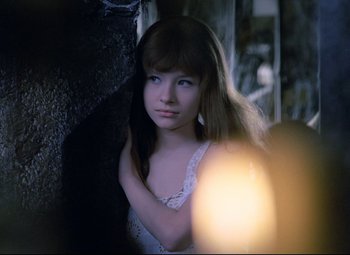 Movie still from “Valerie and Her Week of Wonders” (1970), directed by Jaromil Jires – A young girl in a white dress looking at the camera; Close Up shot, High angle