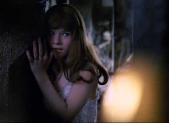 Movie still from “Valerie and Her Week of Wonders” (1970), directed by Jaromil Jires – A young girl leaning against a wall with her hands on her chest; Close Up shot, High angle