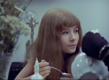 Movie still from “Valerie and Her Week of Wonders” (1970), directed by Jaromil Jires – A young woman with long hair and bangs holding a toothbrush; Close Up shot, Over the shoulder angle