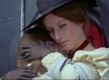 Movie still from “Valerie and Her Week of Wonders” (1970), directed by Jaromil Jires – A woman holding a monkey in her arms; Close Up shot, Over the shoulder angle