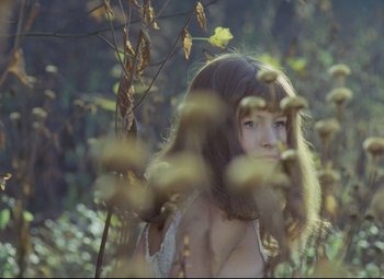 Movie still from “Valerie and Her Week of Wonders” (1970), directed by Jaromil Jires – A young girl is standing in the grass; Close Up shot, High angle